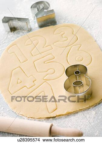 Picture - Cutting out Number Shape Biscuits. Fotosearch