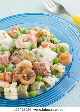 Stock Photograph - Seafood Pasta Spirals with Peas and Herbs. Fotosearch