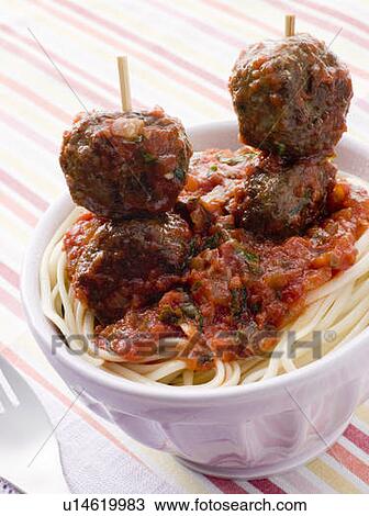 Stock Image - Spaghetti with Meatball Sticks and Spicy Tomato Sauce. Fotosearch