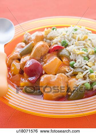 Stock Photograph - Sweet and Sour Chicken with Egg Fried Rice. Fotosearch
