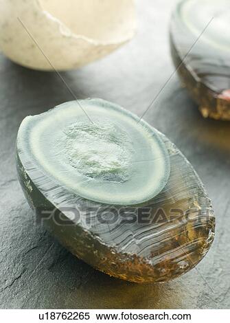 Stock Photography - 1000 Year Egg cut in half with shell. Fotosearch