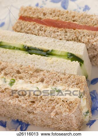 Stock Image - Afternoon Tea Finger Sandwiches- Egg and Cress Smoked Salmon and Cucumber. Fotosearch