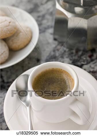 Stock Photography - Cup of Espresso Coffee with Amaretti Biscuit. Fotosearch