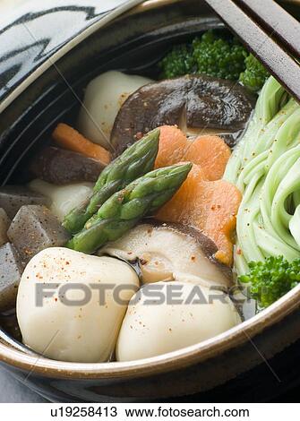 Stock Image - Fish Ball Stew Pot with Vegetables and Spinach Noodles. Fotosearch