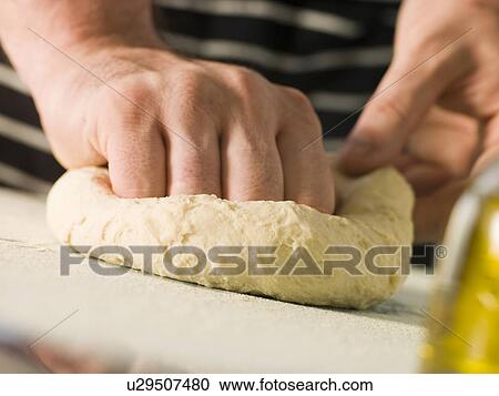 Stock Image - Kneading Pizza Dough. Fotosearch