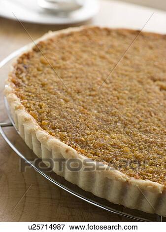 Stock Photo - Whole Treacle Tart on a Cooling Rack. Fotosearch