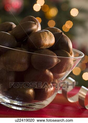 Stock Image - Bowl of Chestnuts in their Shells. Fotosearch