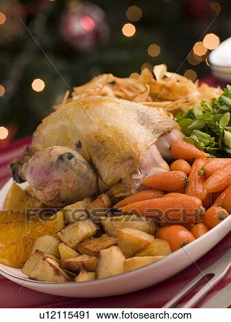 Stock Image - Pheasant Roasted with Orange Carrots Watercress and Parsnip Crisps. Fotosearch