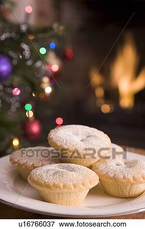 Stock Photo - Plate of Mince Pies Log Fire and Christmas Tree. Fotosearch