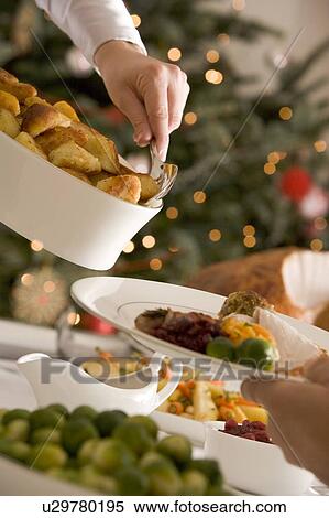 Serving Roast Potatoes at Christmas Lunch View Large Photo Image Stock Photography - Serving Roast Potatoes at Christmas Lunch. Fotosearch