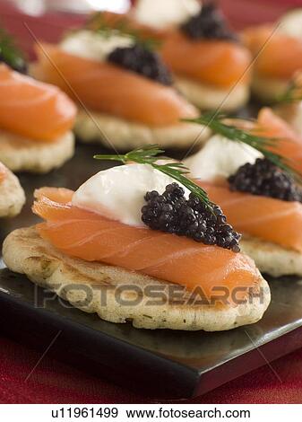 Stock Photo - Smoked Salmon Blinis Canap s with Sour Cream and Caviar. Fotosearch