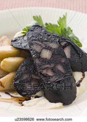 Stock Photograph - Boudin Noir Caramelised Apples and Pomme Puree with Balsamic. Fotosearch