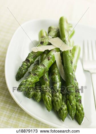 Stock Image - Chargrilled Asparagus Spears with Parmesan Cheese Shaves. Fotosearch