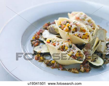 Conchiglioni Pasta filled with Mediterranean Vegetables and Baby Artichokes View Large Photo Image Stock Image - Conchiglioni Pasta filled with Mediterranean Vegetables and Baby Artichokes. Fotosearch