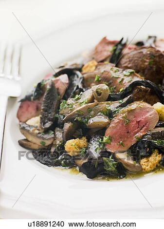 Stock Image - Fried Flat Mushrooms and Chicken Livers with Croutons. Fotosearch