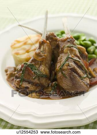 Stock Image - Grilled Lamb Cutlets Chasseur sauce Pomme Anna and Baby Broad beans. Fotosearch