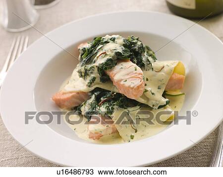 Stock Image - Open Lasagne of Salmon and Spinach with a Saffron Cream. Fotosearch