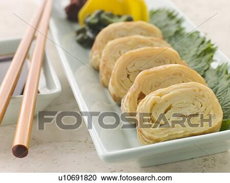 Stock Image - Rolled Dashi Omelette with Pickled Vegetables Soy and Shiso. Fotosearch