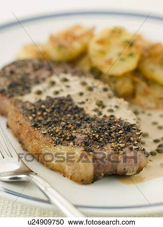 Stock Image - Steak au Poirve' with Saut Potatoes. Fotosearch
