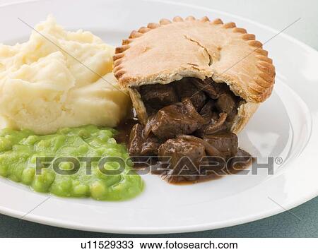 Stock Image - Steak Pie and Mash with Mushy Peas. Fotosearch