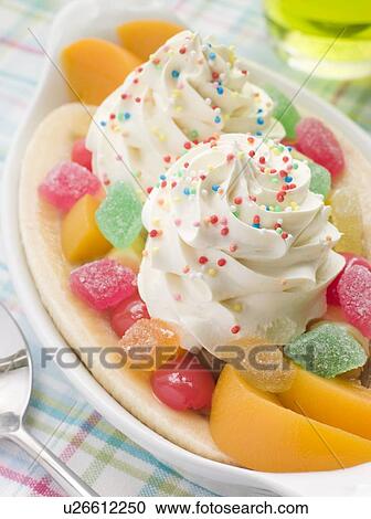 Stock Image - Banana Split with Peaches and Whippy Ice Cream. Fotosearch