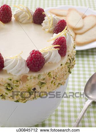 Stock Image - Bowl of Chilled Lemon Souffle with Biscuits. Fotosearch