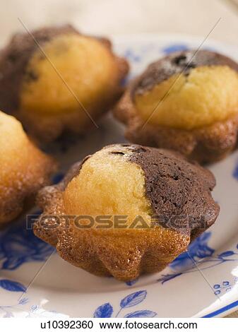 Stock Image - Chocolate and Vanilla Cake cooked in Brioche Tins. Fotosearch
