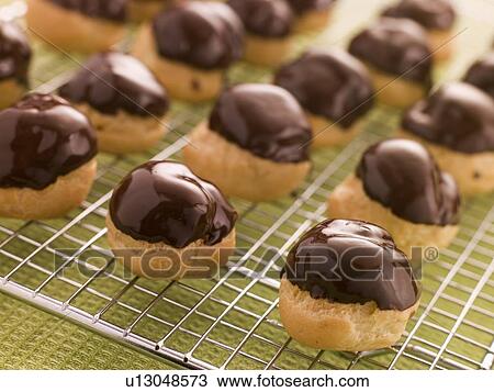 Stock Image - Chocolate dipped Profiteroles. Fotosearch