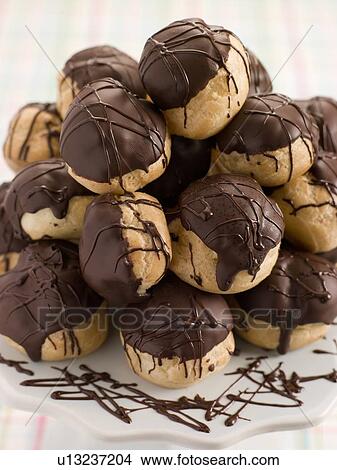 Picture - Chocolate Profiteroles on a Cake Stand. Fotosearch