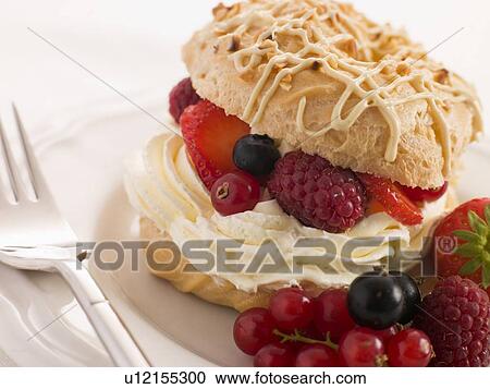 Stock Image - Choux Bun filled with Mixed Berries and Chantilly Cream. Fotosearch