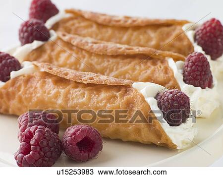 Stock Image - Cream Brandy Snaps with Raspberries. Fotosearch