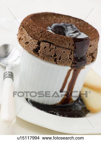 Hot Chocolate Souffle with Chocolate sauce and Langue de Chat Biscuits View Large Photo Image Picture - Hot Chocolate Souffle with Chocolate sauce and Langue de Chat Biscuits. Fotosearch