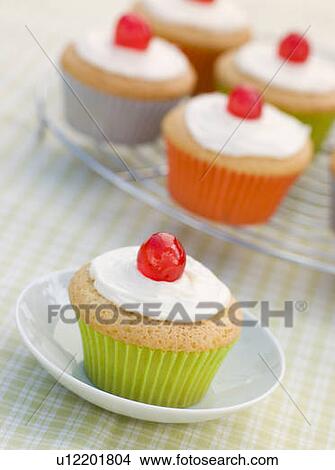 Picture - Iced Cup Cakes with Glace Cherries. Fotosearch