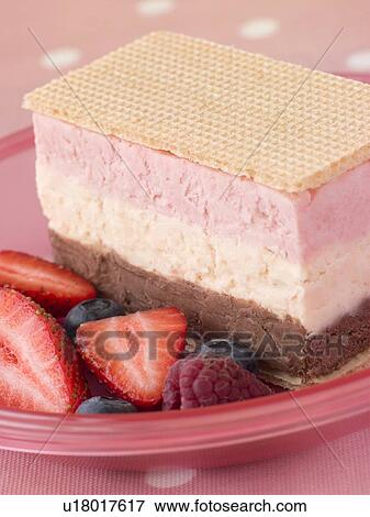 Stock Photo - Neapolitan Ice Cream with Wafer Biscuits and Berries. Fotosearch