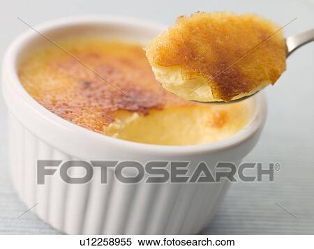 Stock Photography - Spoonful of Cr me Brulee. Fotosearch
