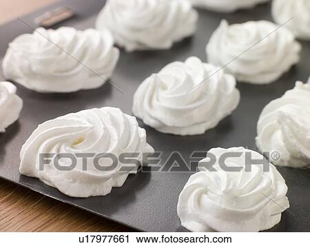 Stock Image - Tray of piped Meringues. Fotosearch