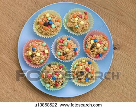 Stock Image - White Chocolate and Marshmallow Rice Crisp Cakes with Sugar Coated Chocolate Drops. Fotosearch