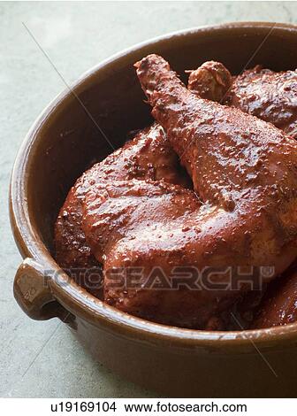 Picture - Chicken Legs Marinating in Tandoori Paste. Fotosearch