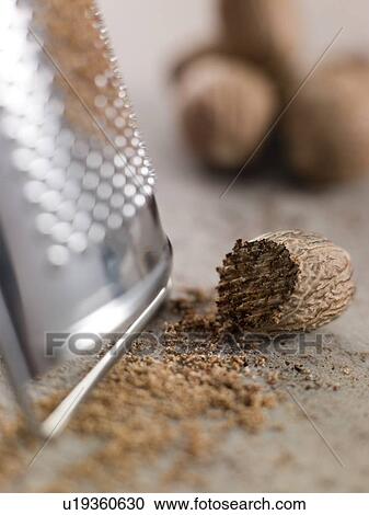 Stock Image - Nutmeg and grater. Fotosearch