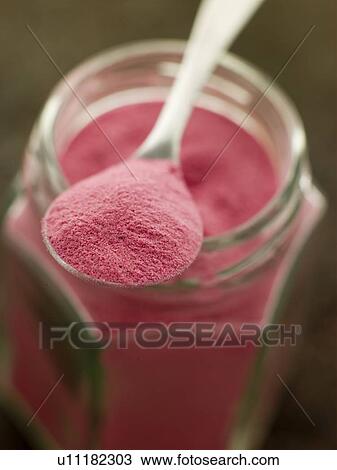 Stock Image - Spoon of Sel Rose on a Glass Jar. Fotosearch