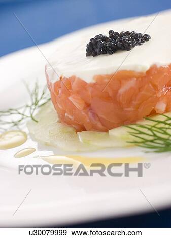 Stock Photo - Tartare of Wild Salmon Creme Fraiche Cucumber Caviar and Lemon Oil. Fotosearch