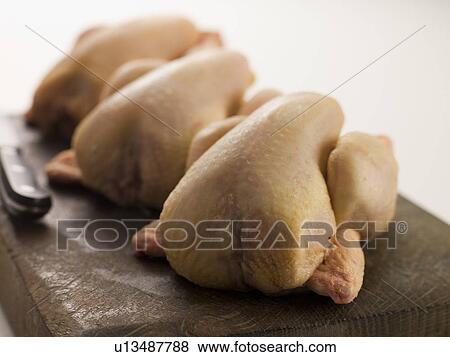Three Whole Poussins on a Chopping Board View Large Photo Image Stock Photo - Three Whole Poussins on a Chopping Board. Fotosearch