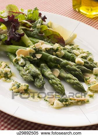 Stock Photography - Asparagus Spears with Polonaise Vinaigrette and Salad Leaves. Fotosearch