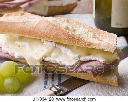 Brie and Ham Baguette with White Wine and Grapes View Large Photo Image Stock Photo - Brie and Ham Baguette with White Wine and Grapes. Fotosearch