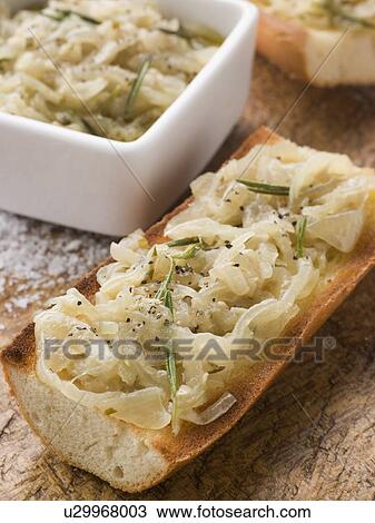 Stock Image - Confit of Onions on Toasted Baguette. Fotosearch
