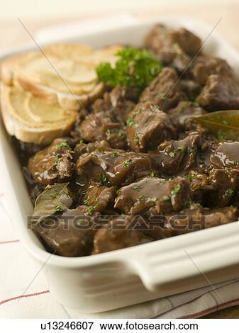 Stock Photo - Dish of Beef Carbonnade with Mustard Crouton. Fotosearch