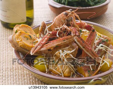 Stock Photography - Dish of Bouillabaisse with Rouille Croutes and Gruyere Cheese. Fotosearch