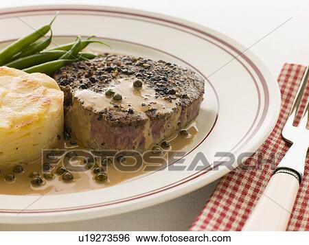 Stock Photograph - Filet Mignon au Poirve' with French Beans and Pomme Anna. Fotosearch