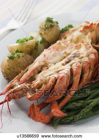 Half a Lobster Thermidor with New Potatoes and Asparagus Spears View Large Photo Image Stock Photo - Half a Lobster Thermidor with New Potatoes and Asparagus Spears. Fotosearch