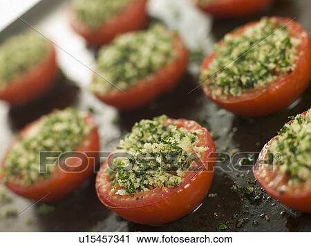 Stock Image - Oven Roasted Tomatoes with a Provencale Crust. Fotosearch